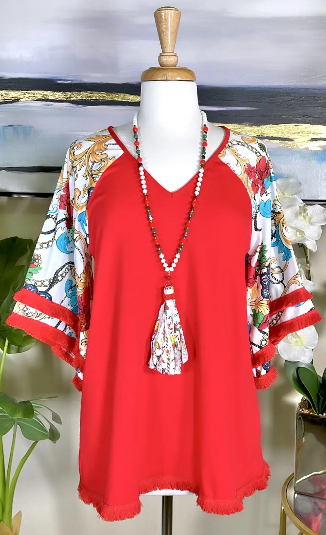 Red Top with white design bell sleeves and fringe trim